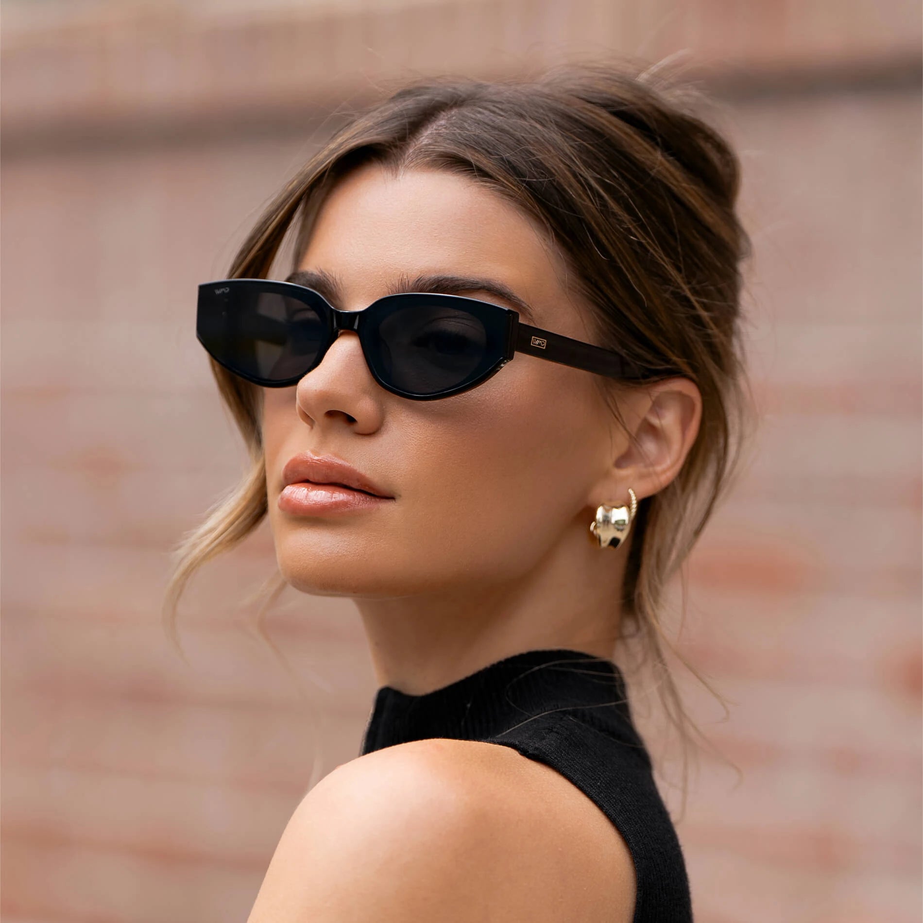 Women model wearing black WMP Eyewear ASTRA Cateye sunglasses