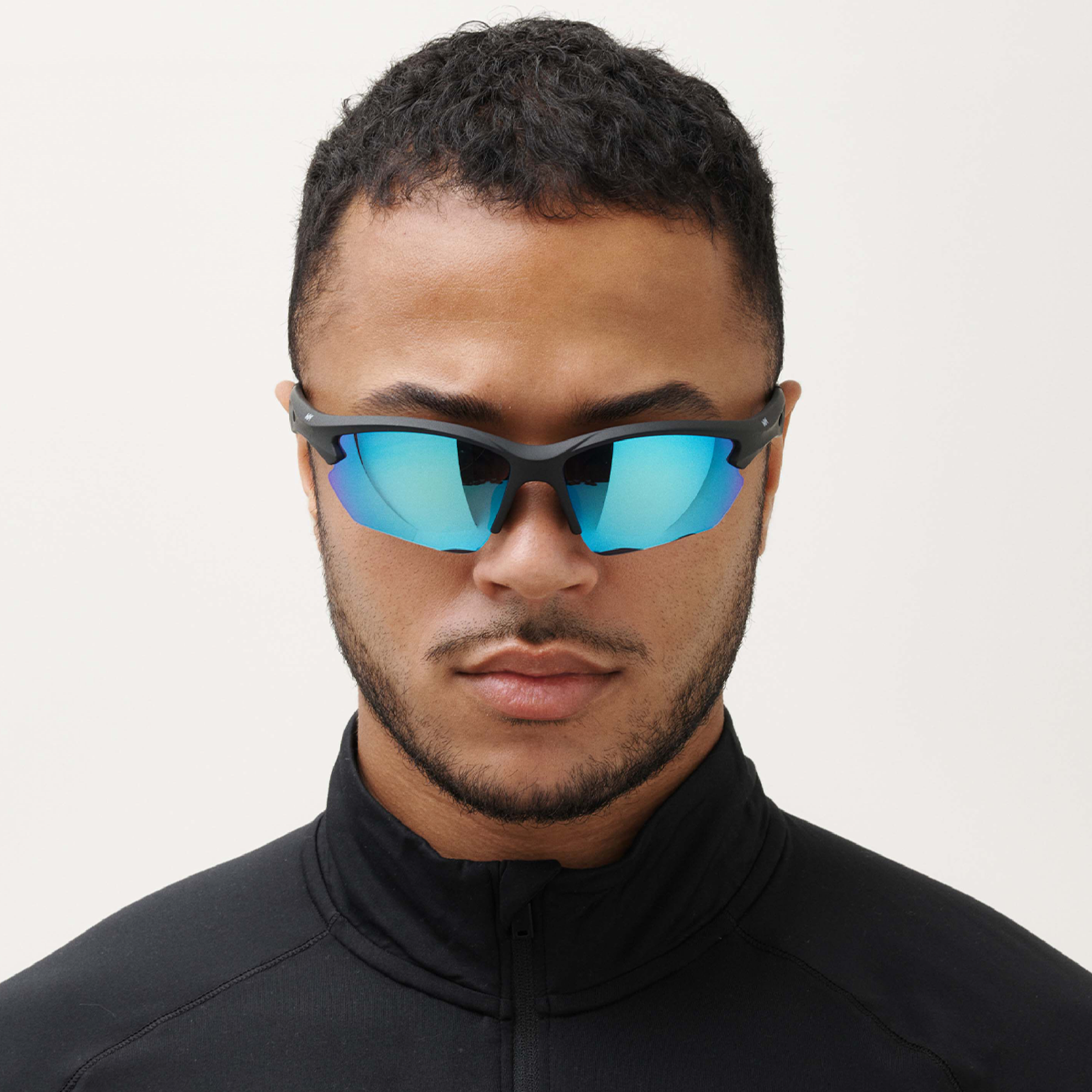 Man wearing reflective sports sunglasses by messy weekend